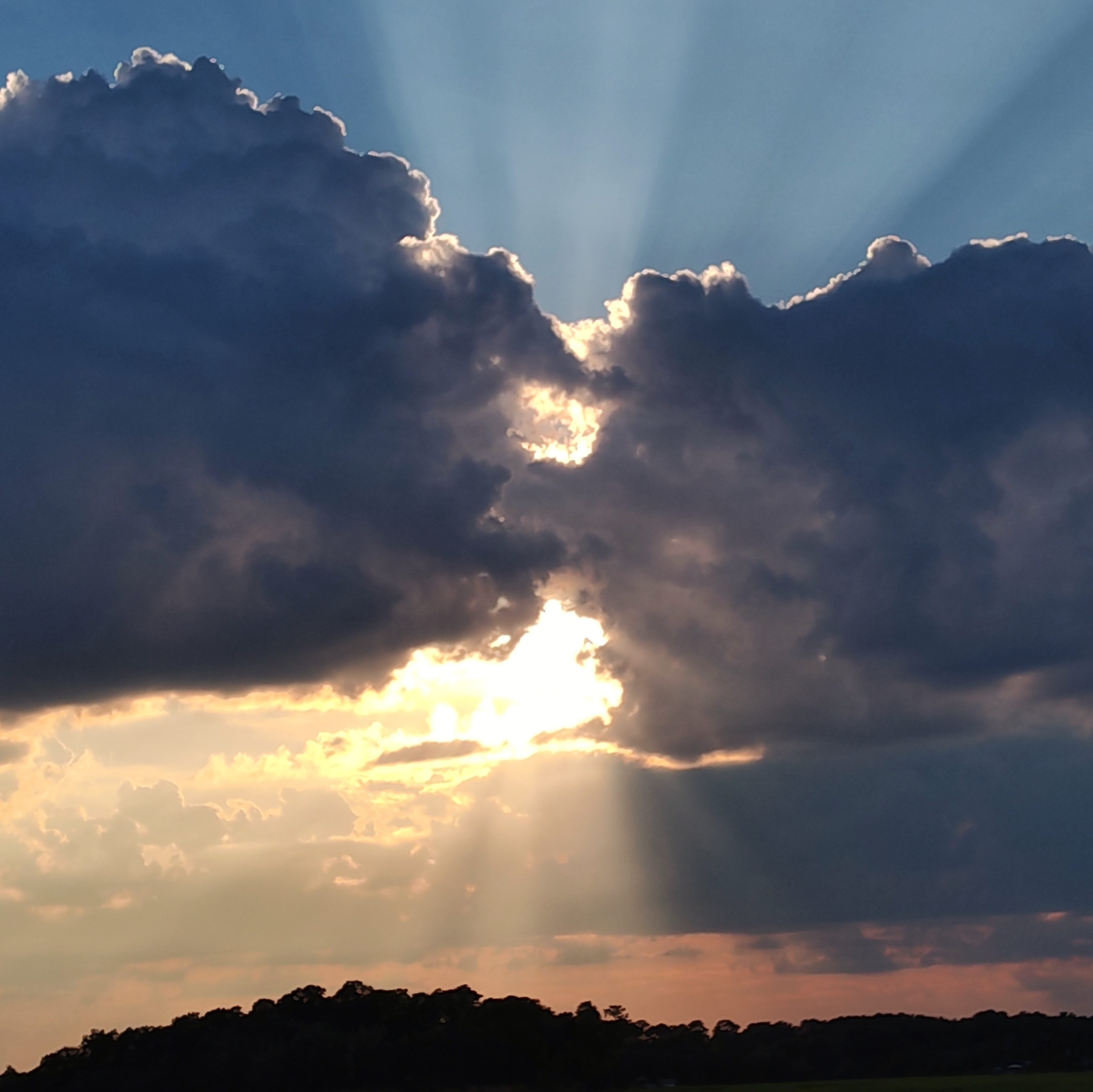 Heavenly clouds with light rays emanating